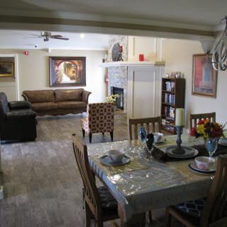 A cozy and stylish living space featuring a comfortable sofa, dining table, and elegant decor.