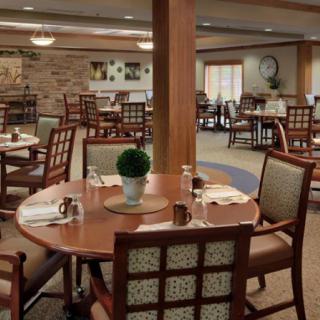 An elegantly arranged dining area with neatly set tables and comfortable seating.