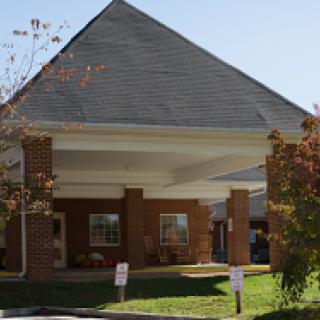 A modern brick building with a sloped roof and welcoming entrance.