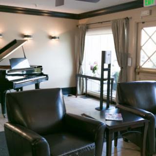 A sophisticated lounge area featuring a piano and comfortable seating, perfect for relaxation.