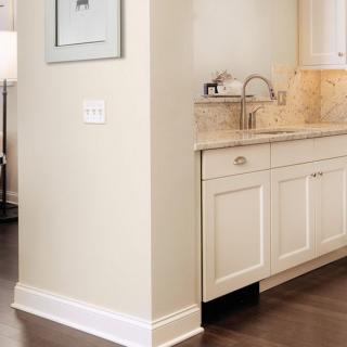 A modern kitchen interior featuring a sink and cabinets with a light-colored countertop.