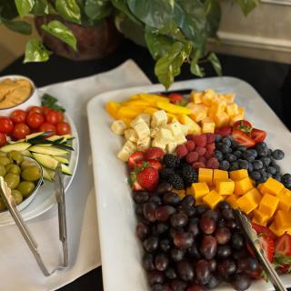 A colorful spread featuring a variety of fruits, cheeses, and vegetables on a serving platter.