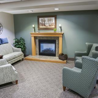 A cozy living room with a fireplace and comfortable seating.