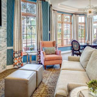 A stylish living room with modern decor featuring a comfortable armchair and large windows.