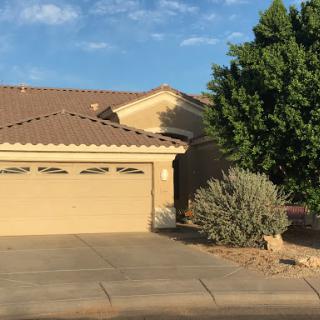 A view of a single-story house with a well-maintained exterior and landscaping.