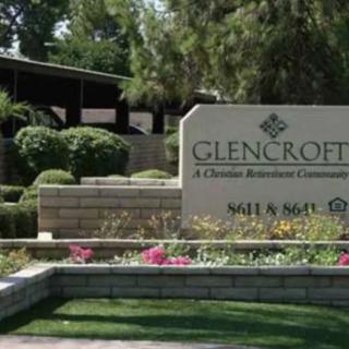 Entrance sign to a community with well-maintained landscaping and greenery.