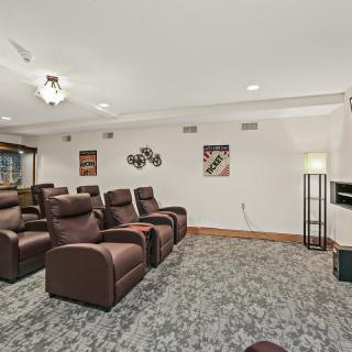 A cozy home theater featuring comfortable recliner seating and modern decor.