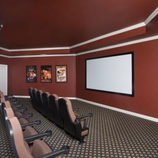 A home theater room featuring comfortable seating and a large movie screen.
