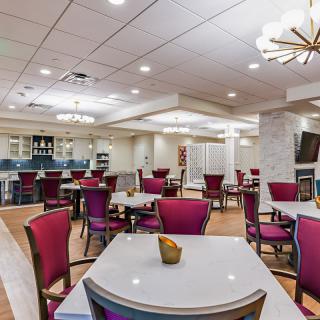 A modern dining room with stylish seating and elegant lighting.