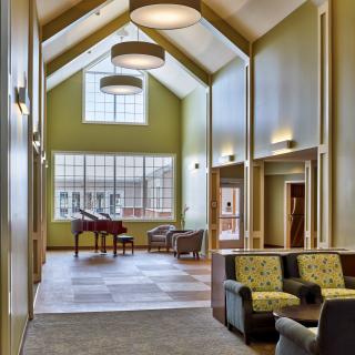 A modern lobby featuring comfortable seating, large windows, and contemporary lighting fixtures.
