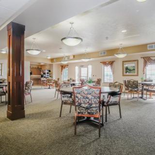 A spacious dining area with tables, chairs, and ambient lighting.