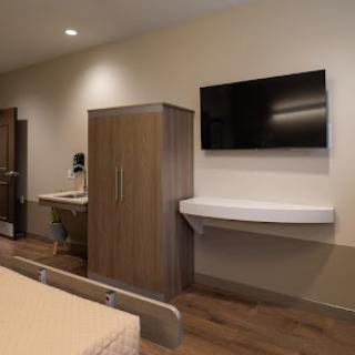 A modern and clean hospital room equipped with essential amenities.