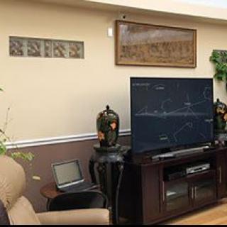 A cozy living room with a large TV and decorative elements.