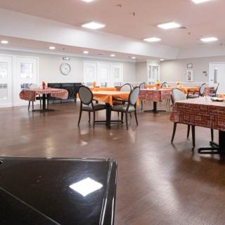 An empty dining area with tables and chairs arranged neatly.