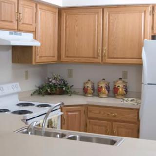 A cozy kitchen with wooden cabinets and modern appliances.