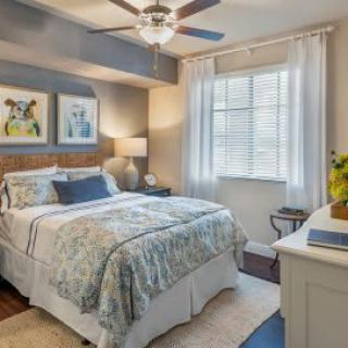 Cozy bedroom with stylish decor and natural lighting.