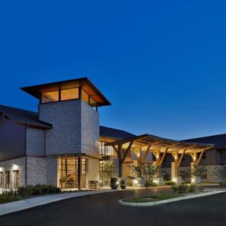 A modern architectural building illuminated at night.