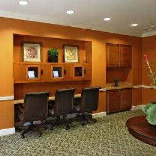 A modern office workspace with desks and chairs.