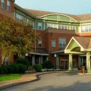 An elegant building with a welcoming entrance surrounded by greenery.