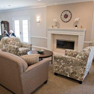 A cozy living room featuring a fireplace, comfortable seating, and elegant interior design.