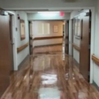 A clean and well-lit hallway in a hospital setting.