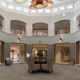 A spacious modern lobby featuring elegant furnishings and a high ceiling.