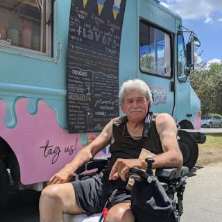 Enjoying a sunny day by the ice cream truck.