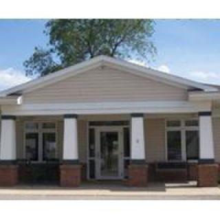 A small building with a prominent entrance and columns.