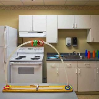 A kitchen with appliances including a stove, refrigerator, and sink.