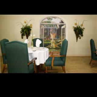 A dining room with a neatly set table and decorative wall art.