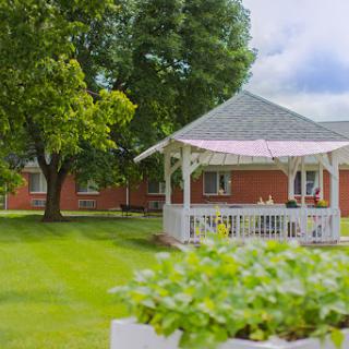 A serene garden featuring a charming gazebo surrounded by lush greenery.