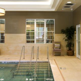 A serene indoor pool area with elegant decor, perfect for relaxation and wellness.