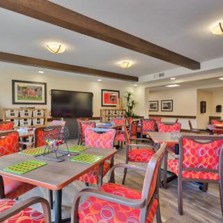 A cozy dining area with colorful chairs and modern decor.