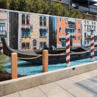 A mural depicting a Venetian scene with a gondola and colorful buildings.