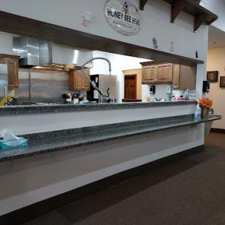 A modern kitchen interior featuring wooden cabinets and a spacious counter area.