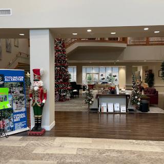 A spacious lobby adorned with festive Christmas decorations, featuring a decorated tree and nutcracker figures.
