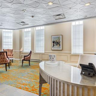 A well-lit office waiting area with a desk and chairs.
