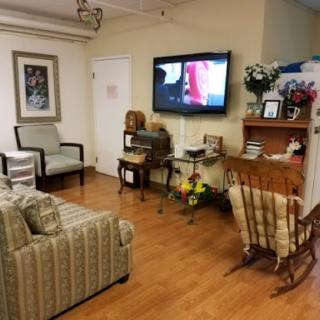 A cozy living room setup featuring a sofa, chairs, and a television.