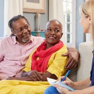 A senior couple having a consultation with a professional in an indoor setting.