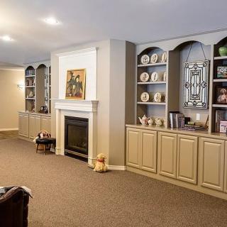 A cozy living room featuring a fireplace surrounded by built-in shelves and elegant decor.