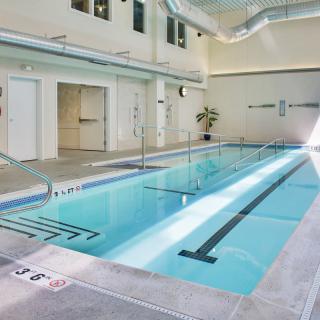 A modern indoor swimming pool located in a fitness center.
