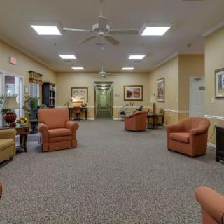 A comfortable and well-lit waiting room with various seating options and decor.
