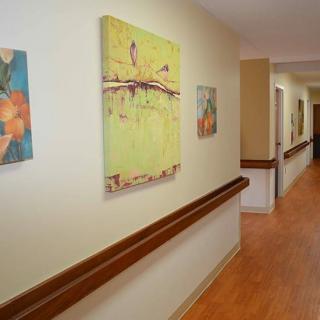 A hallway decorated with colorful paintings on the walls.
