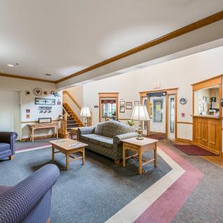 A cozy living room with comfortable sofas, a coffee table, and wooden accents.