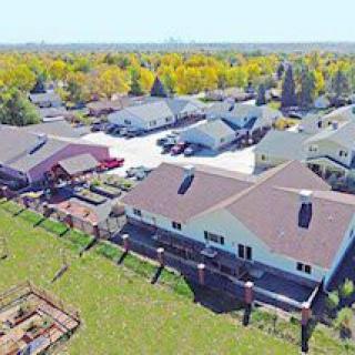 Aerial view of a suburban neighborhood with houses surrounded by greenery.