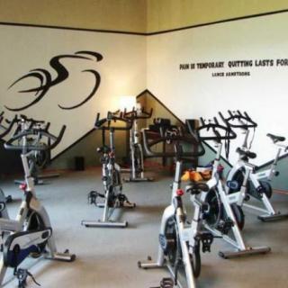 A well-equipped indoor cycling room with multiple exercise bikes.