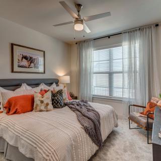 A cozy and well-decorated bedroom with a large bed and soft lighting.