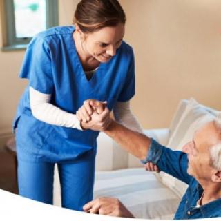A nurse assisting an elderly person in a healthcare setting.