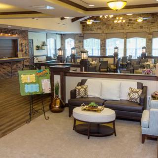 A cozy living room with modern decor, featuring a comfortable couch, coffee table, and ample natural light from large windows.