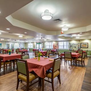 Spacious dining area with elegantly arranged tables and warm lighting.